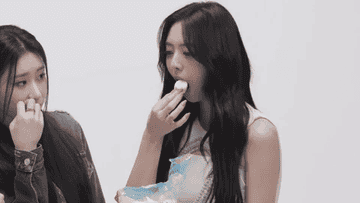 A member of ITZY stuffing marshmallows in her mouth