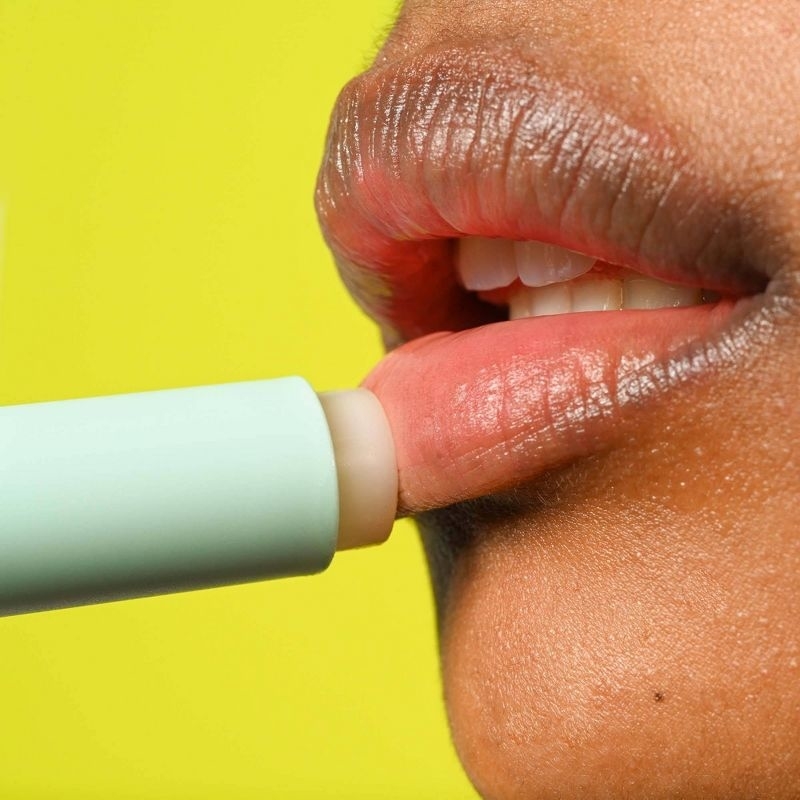 A person applying lip balm