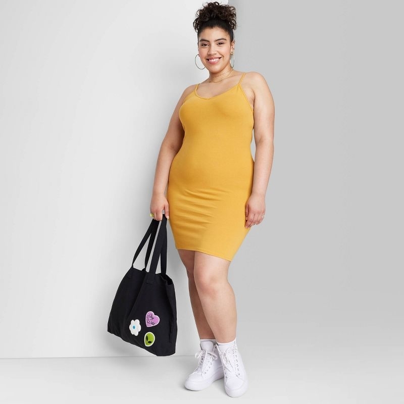 Reviewer wearing the mustard yellow dress