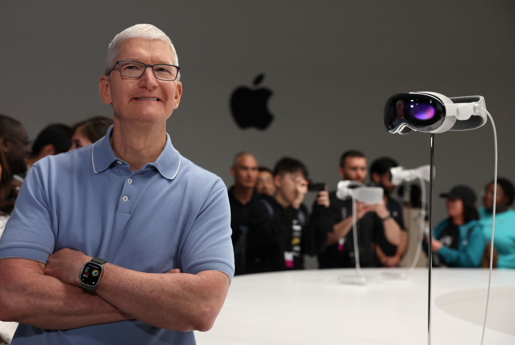 Tim Cook standing next to the Apple Vision Pro