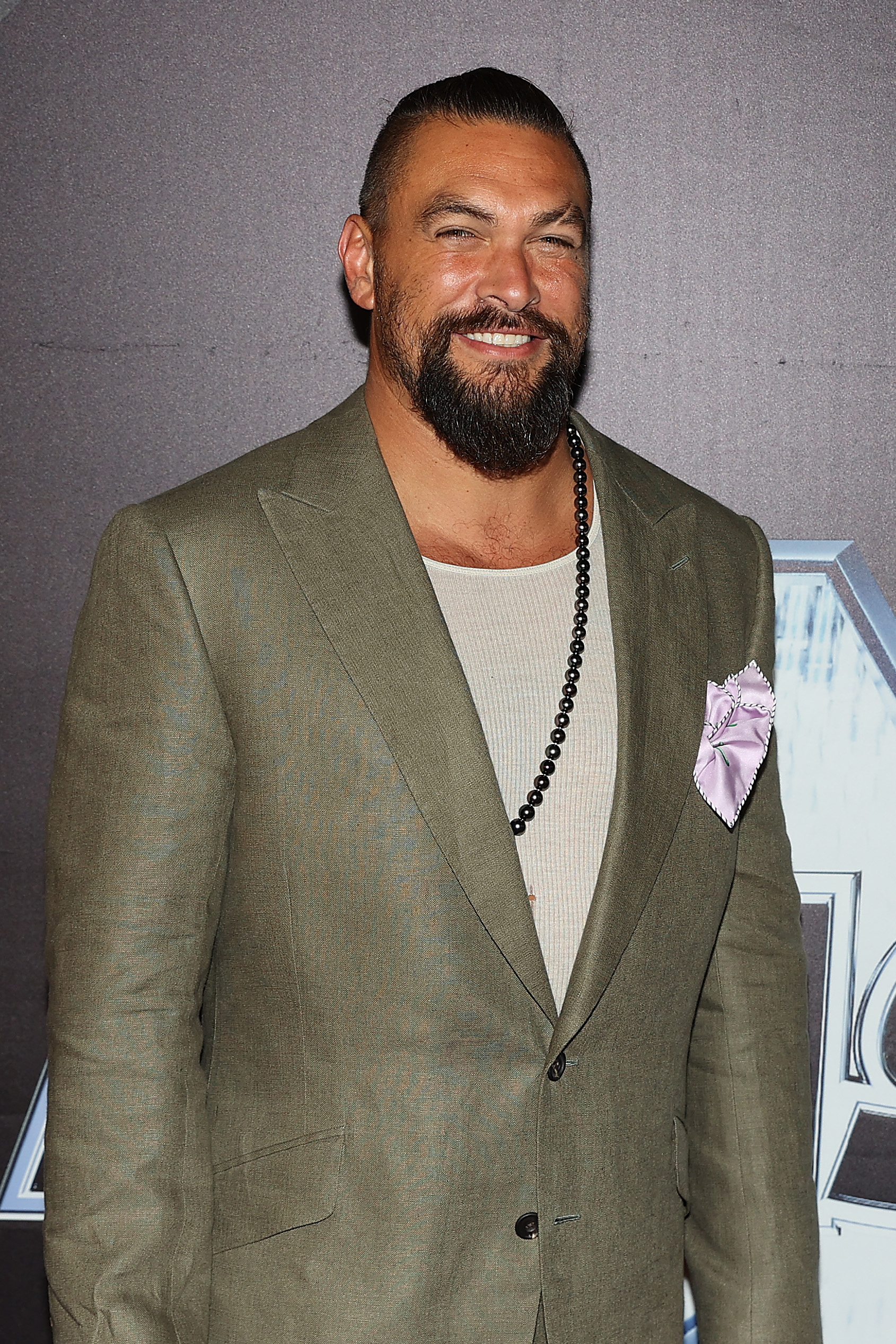 Jason Momoa poses for a photo at an event