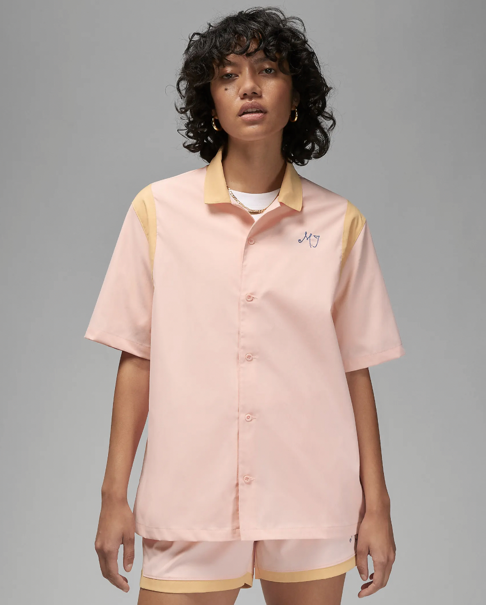 A model wearing the shirt in light pink