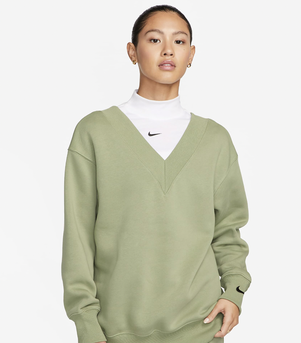 A model wearing the sweater in green