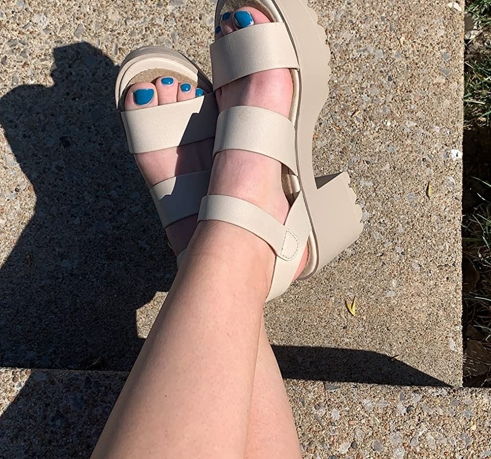 a reviewer wearing the beige sandals