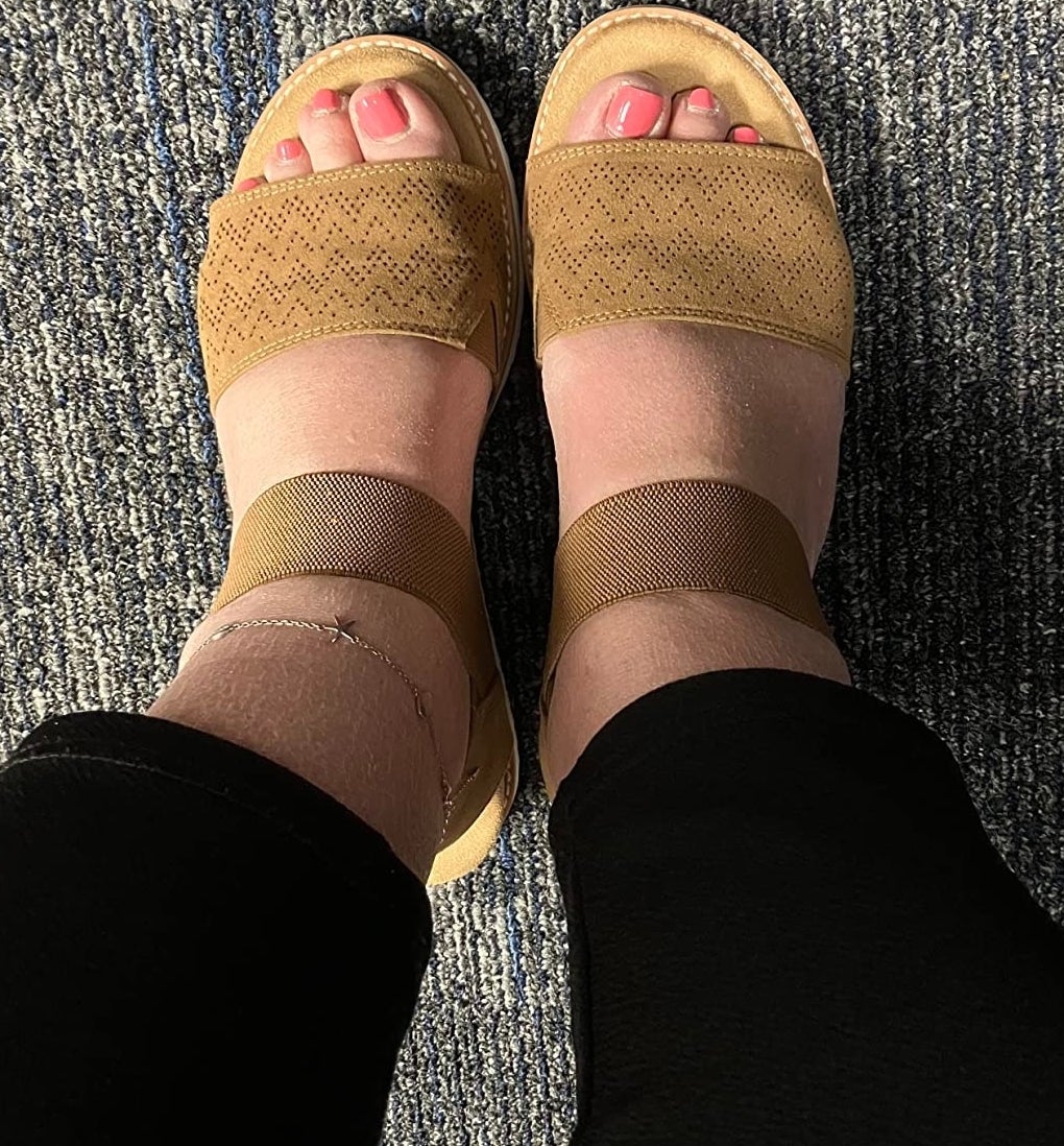 a reviewer wearing the tan sandals