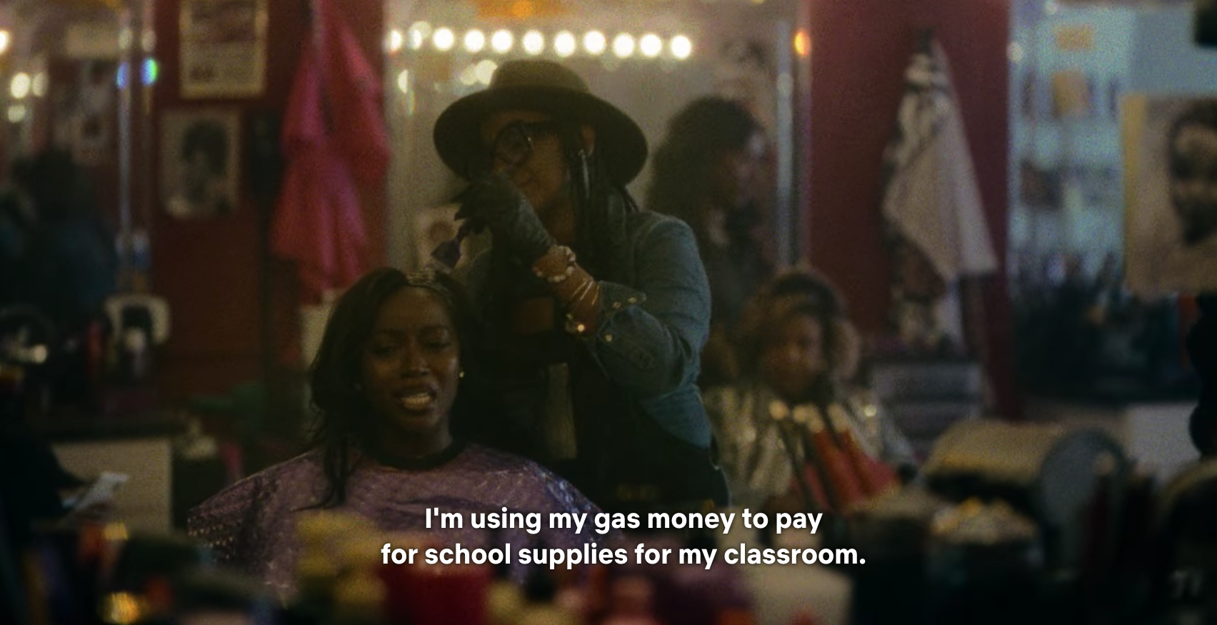A woman getting her hair done as she talks about using gas money to pay for school supplies
