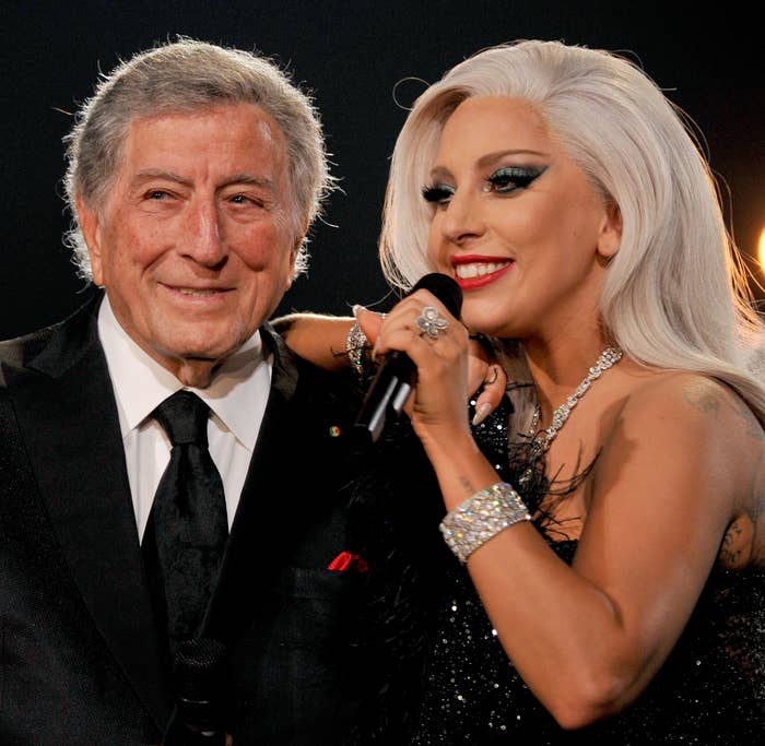 Lady Gaga with her arm on Tony Bennet&#x27;s shoulder as they stand onstage