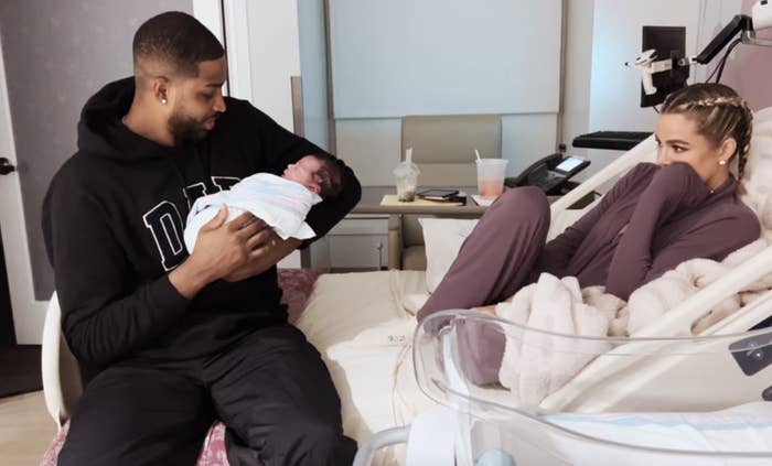 Tristan Thompson holding his and Khloé&#x27;s baby as she looks on
