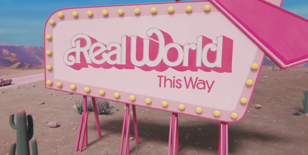 A sign by the road that says &quot;Real World This Way&quot; in a scene from Barbie