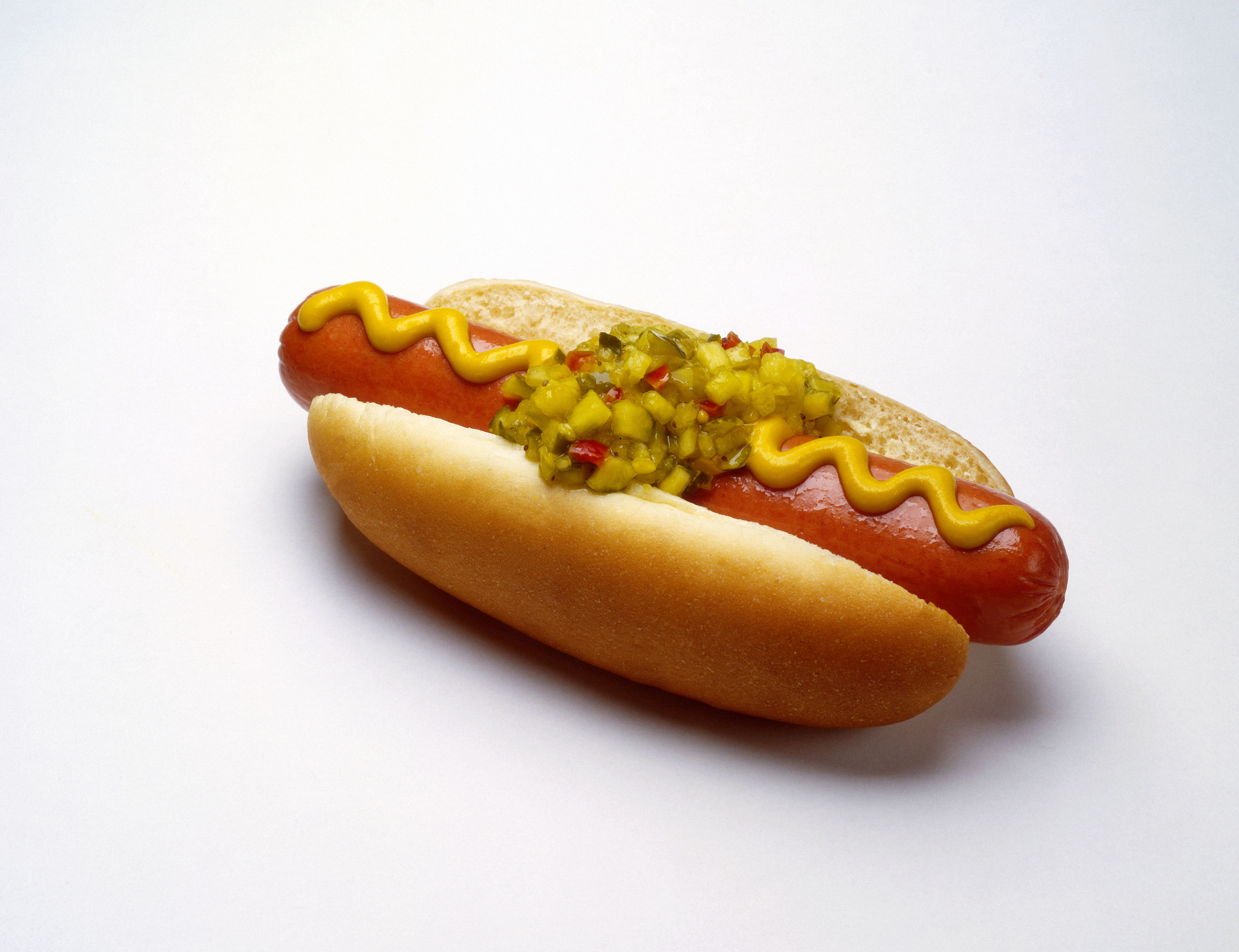 a single hotdog with toppings