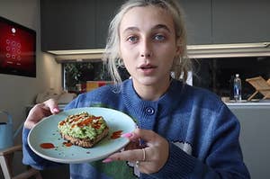 Emma Chamberlain holding a plate with avocado toast on it