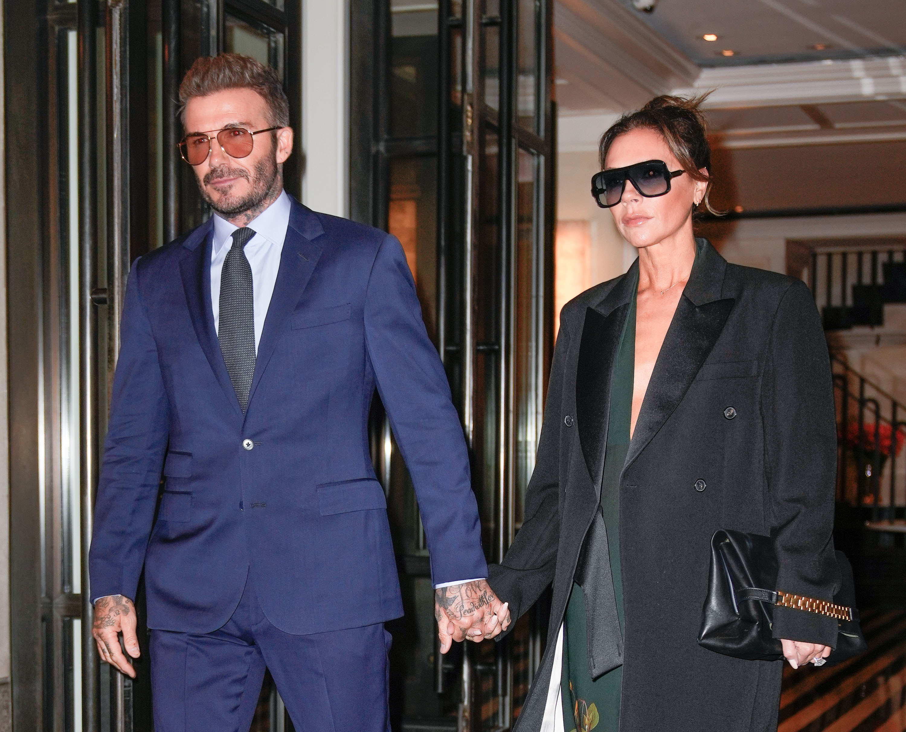 David and Victoria Beckham holding hands
