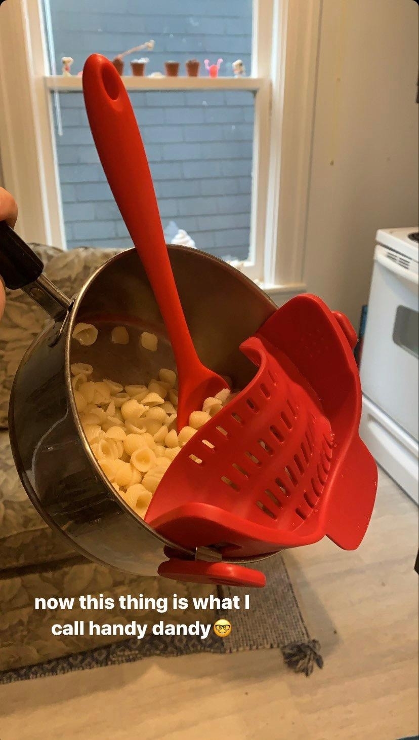 red clip-on strainer on pot of pasta