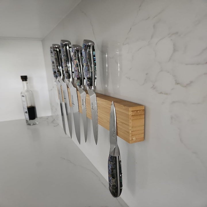 Reviewer image of a knife bar holding knives attached to the wall using the tape