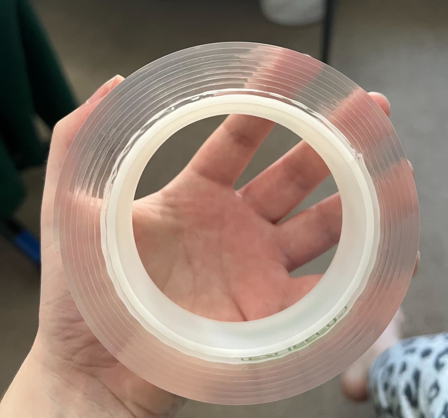 Reviewer holding a roll of the transparent tape