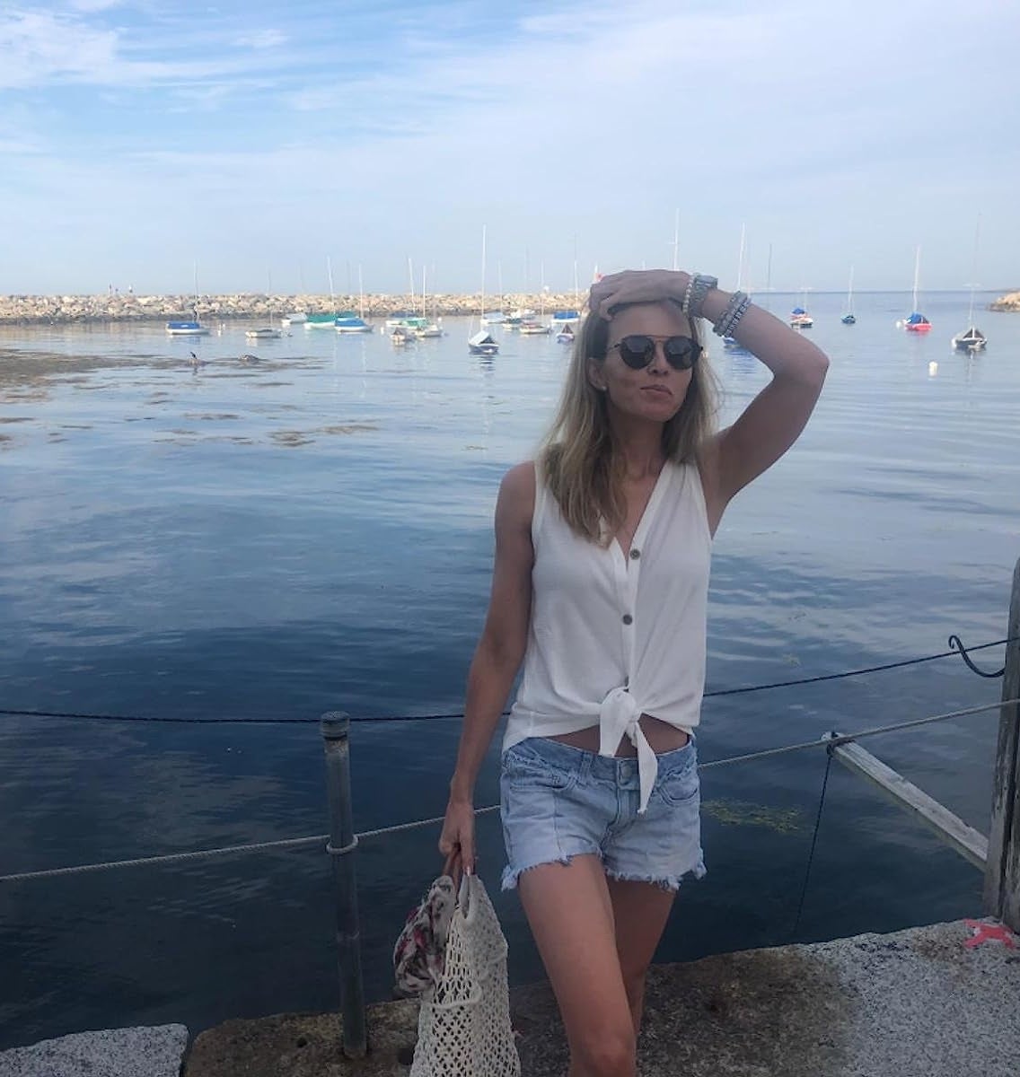 Reviewer wearing the white top with denim shorts