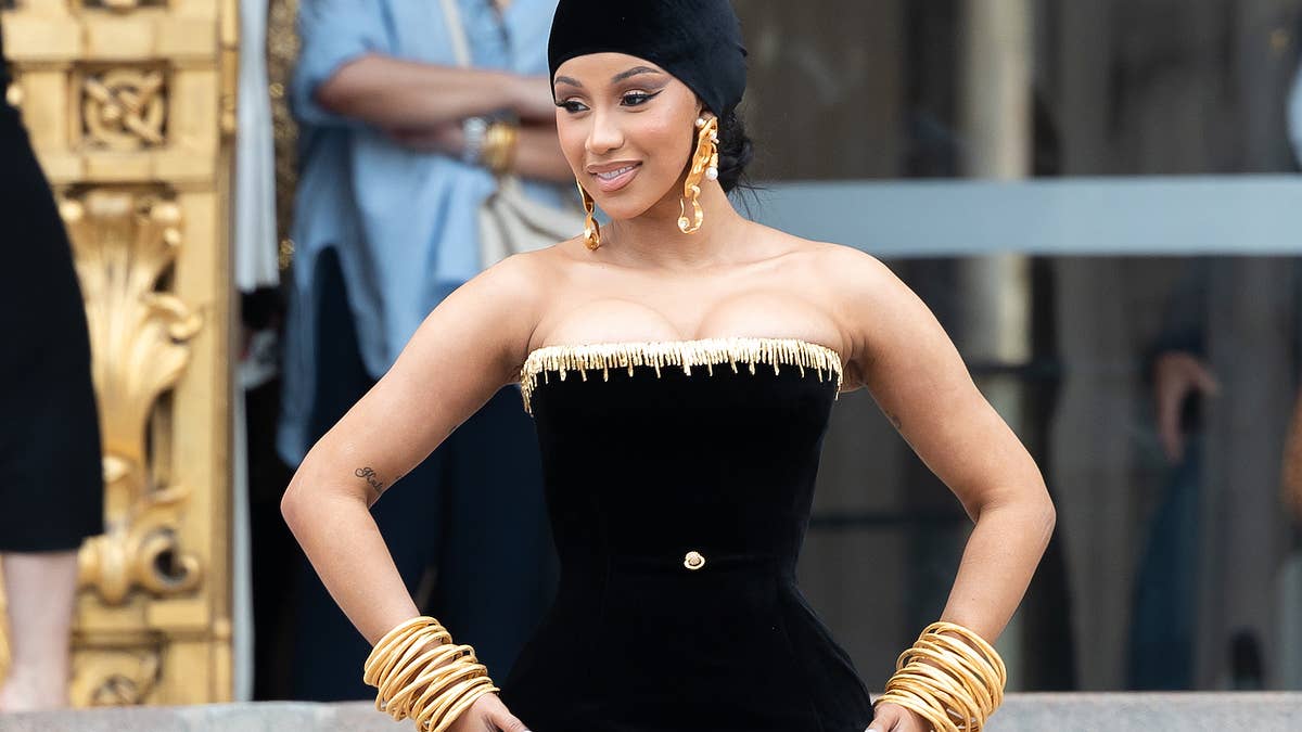 Amid Paris Fashion Week, Cardi stopped and sang some lines from "I Will Always Love You" with an excited busker.