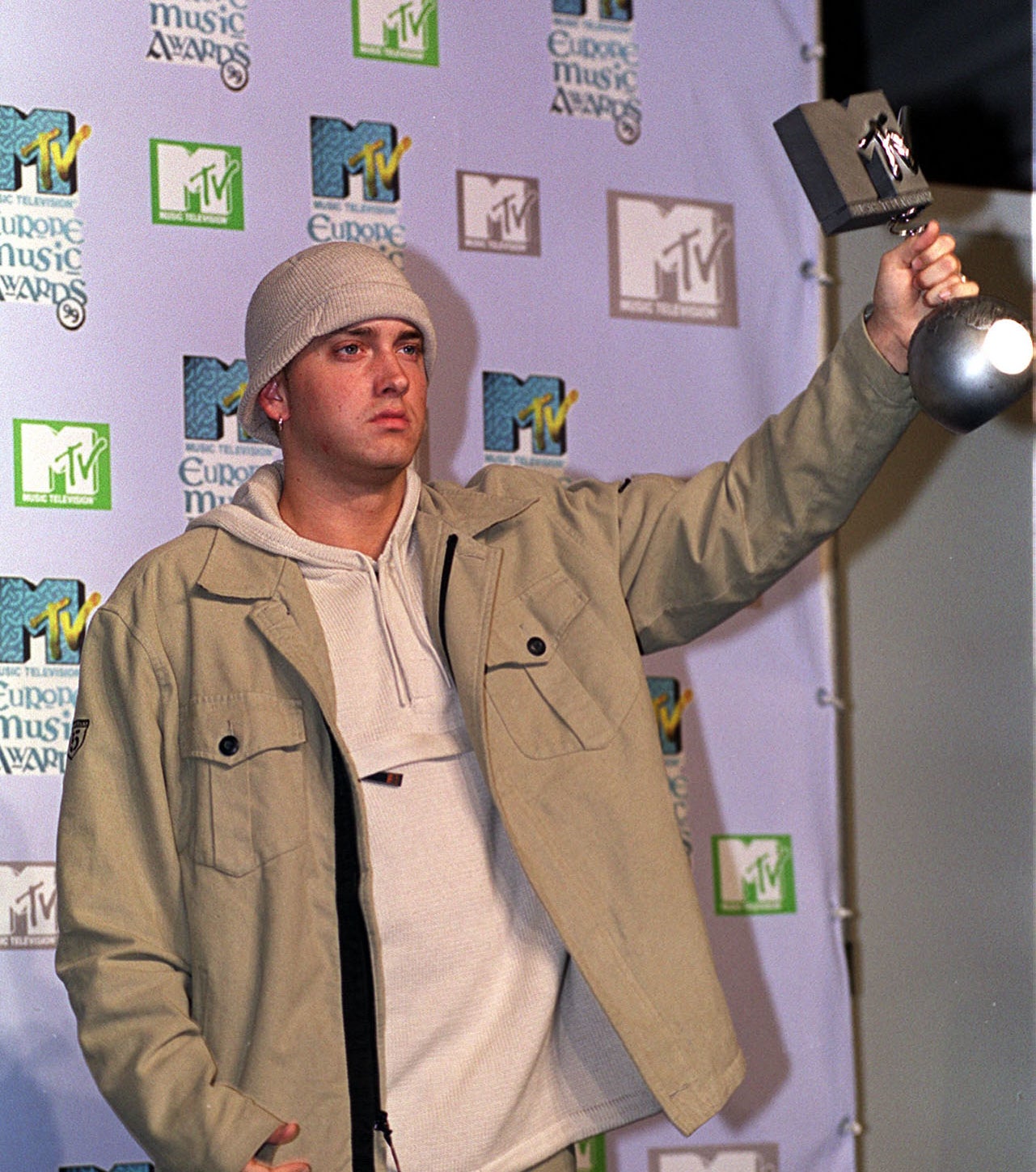 eninem holding up an award