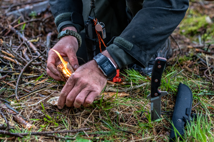 A person starting a fire