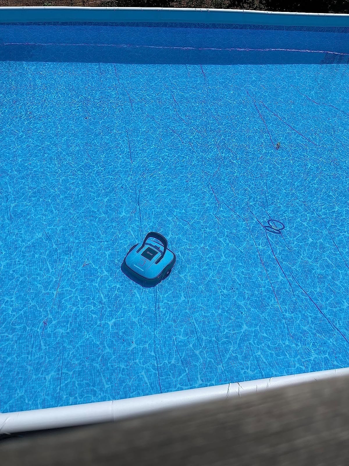 The pool cleaner robot on bottom surface of reviewer&#x27;s pool cleaning it