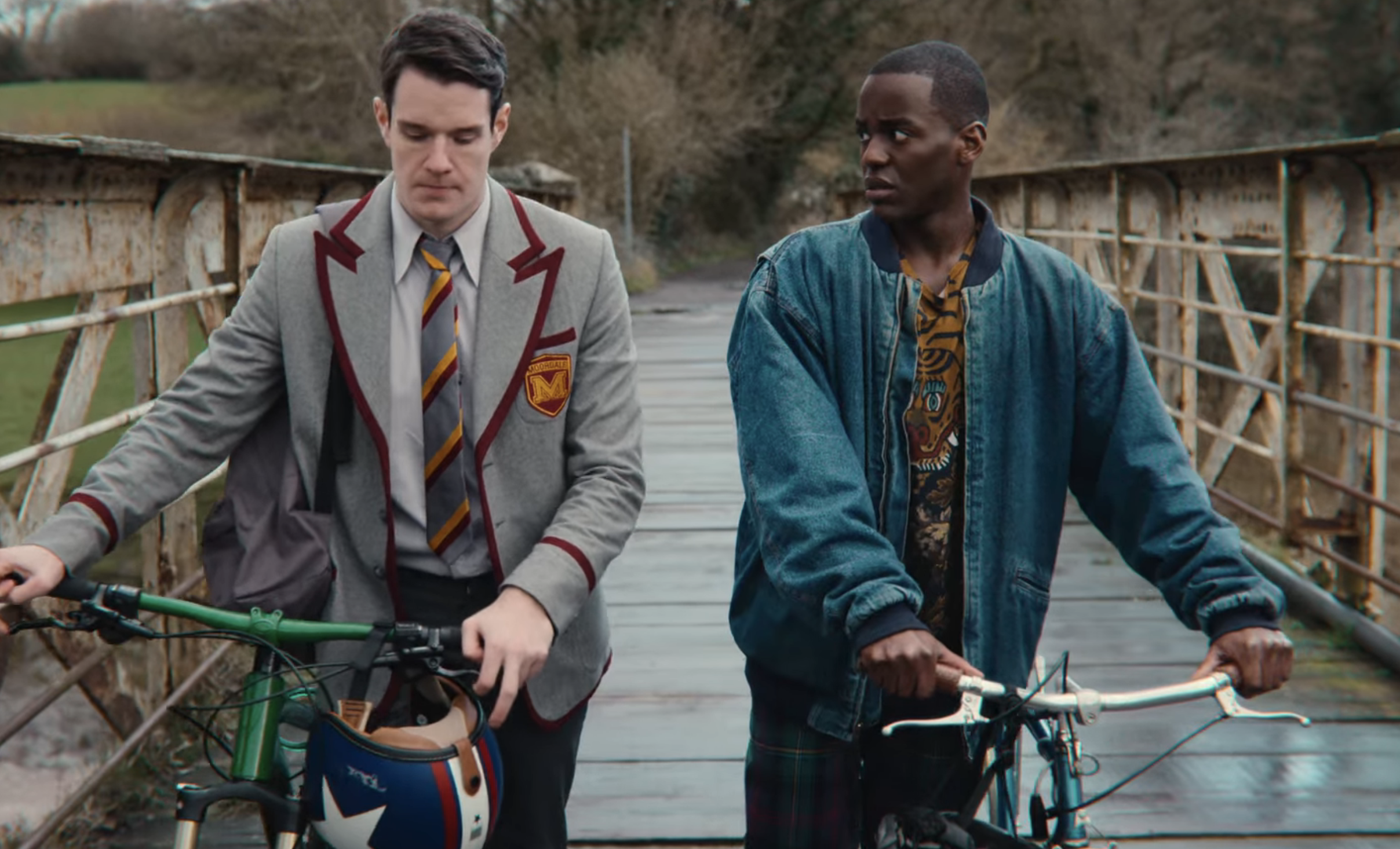 Adam and Eric have a conversation while biking across a bridge