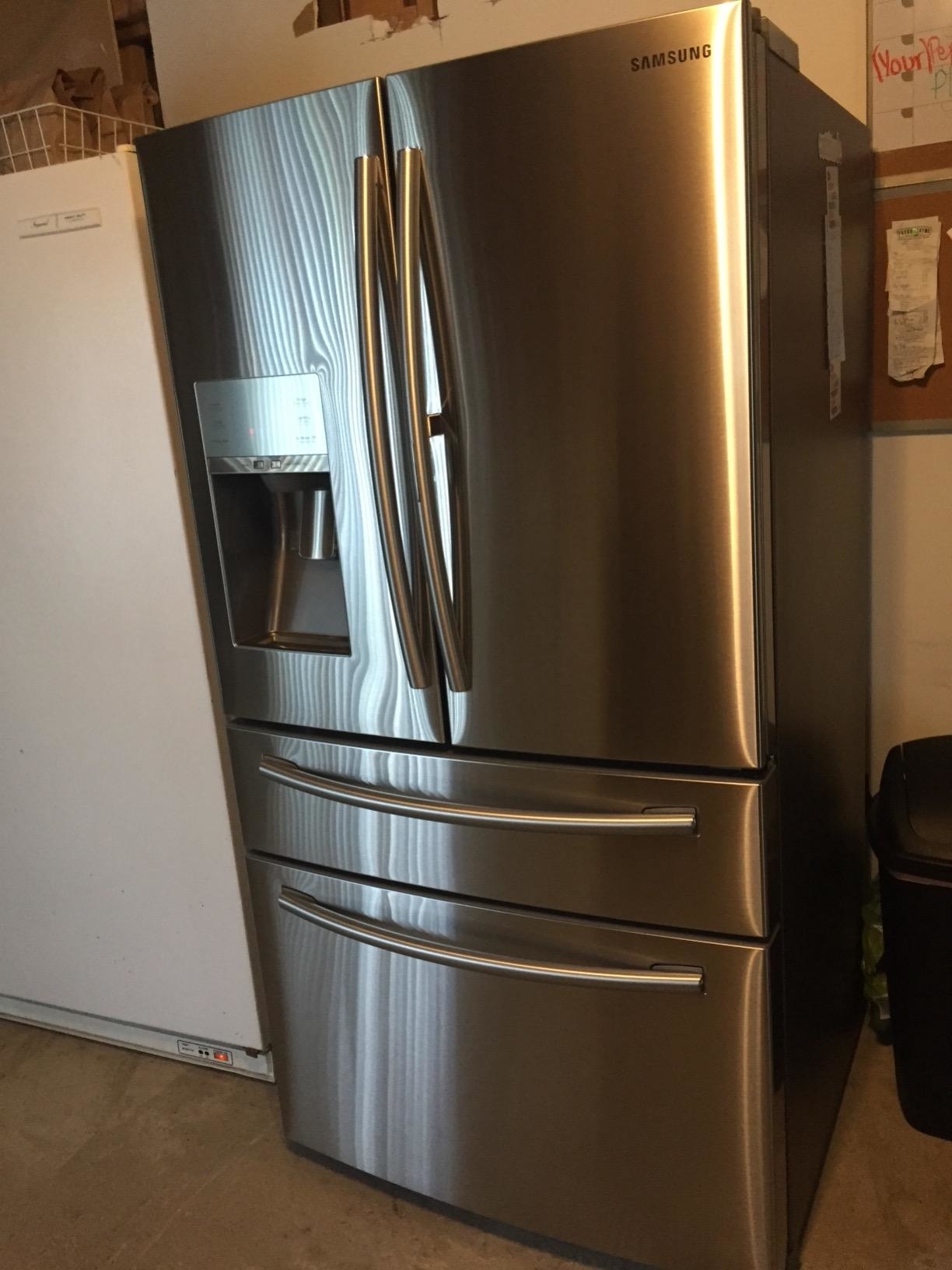 Reviewer image of their stainless steel fridge cleaned with the wipes