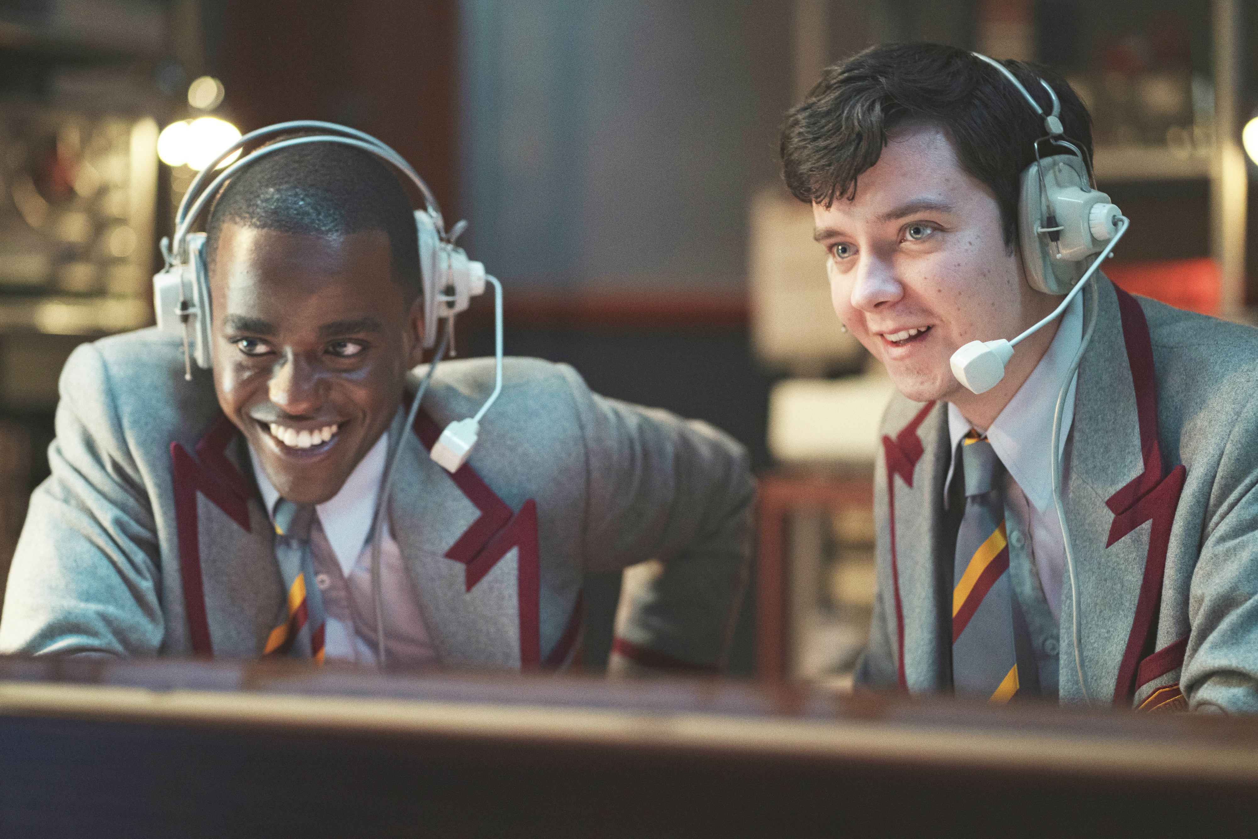 Eric and Otis laugh with headsets on