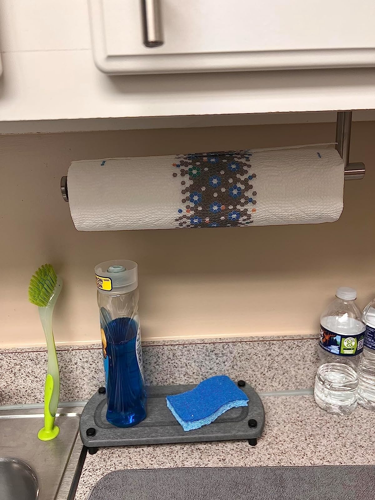 Reviewer's towel rack mounted under cabinet by kitchen sink
