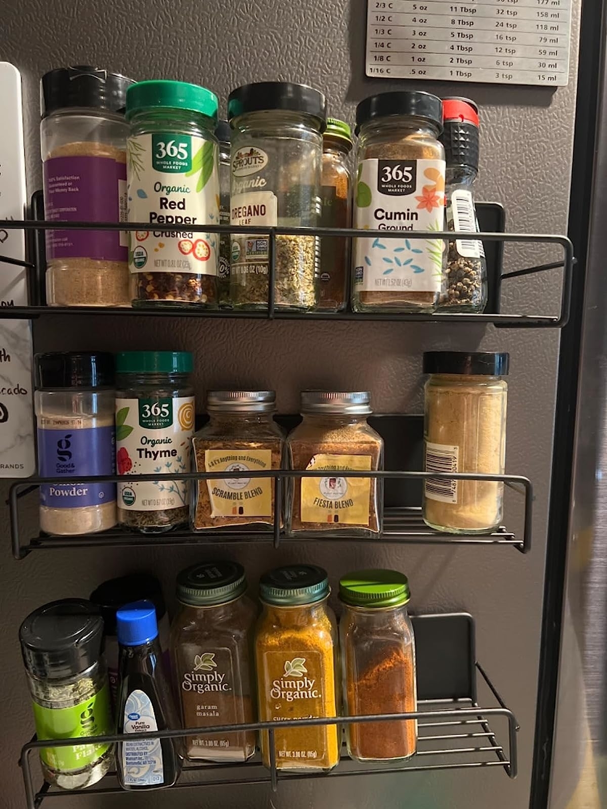 Reviewer's three racks on side of fridge storing spices