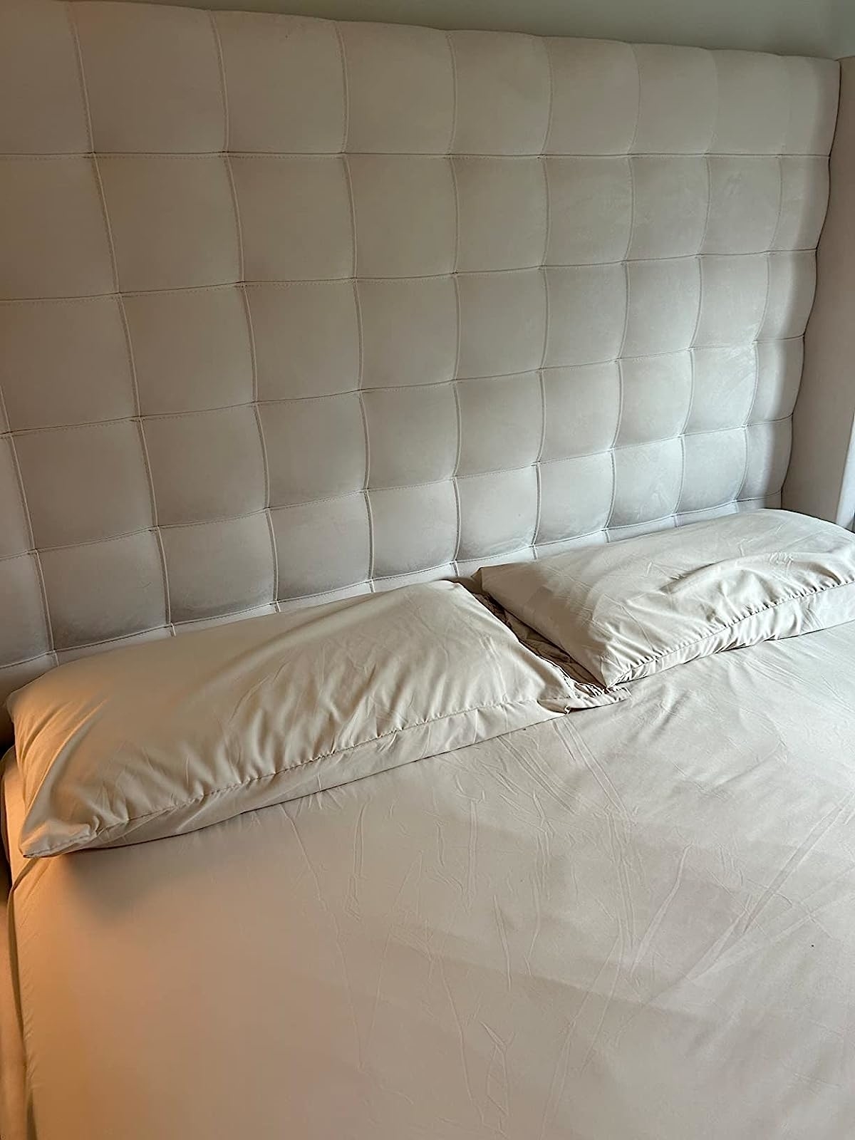 Reviewer image of the beige sheets on their bed