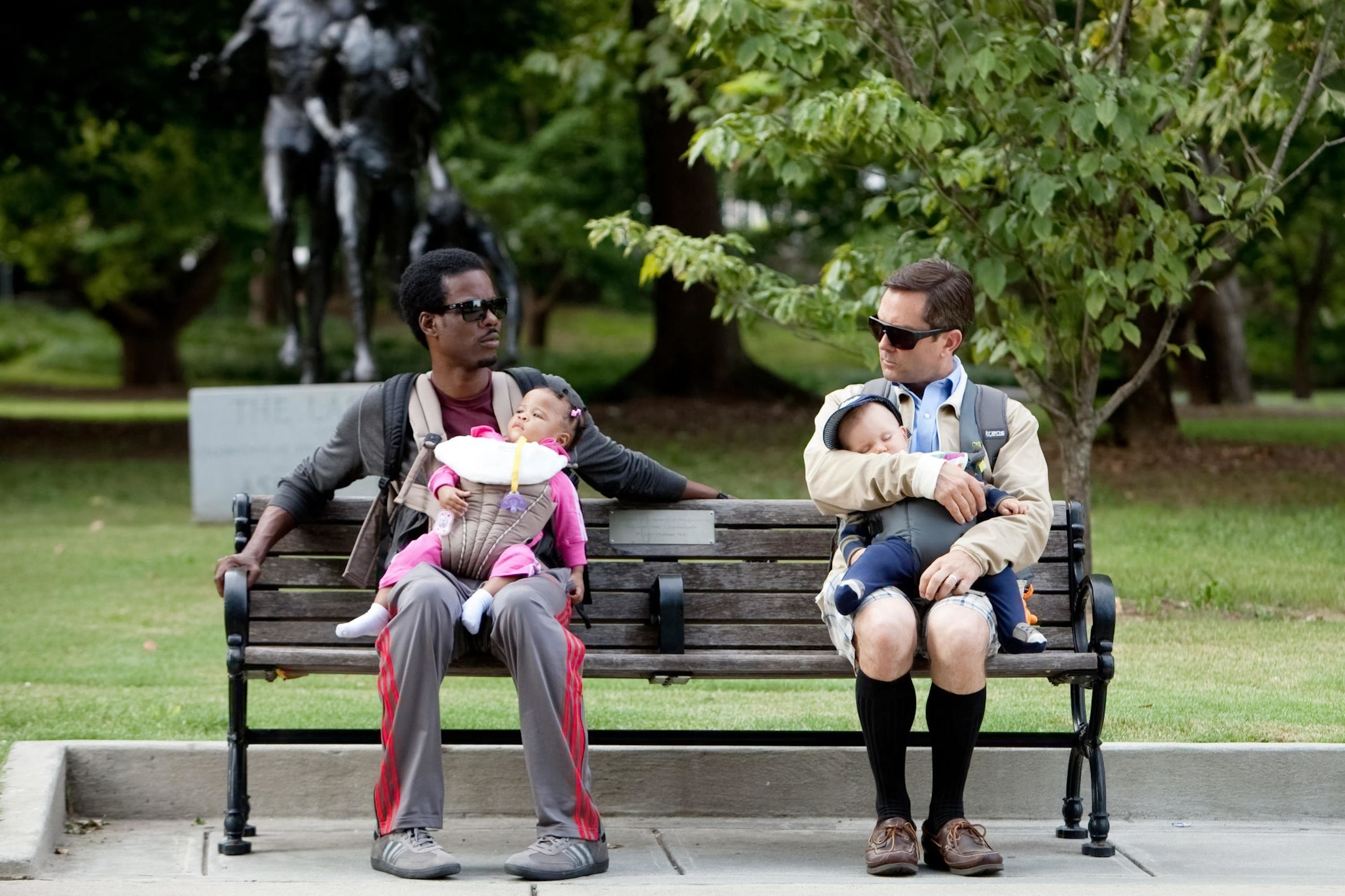 Chris Rock and Tom Lennon sitting on a bench with babies in What to Expect When You&#x27;re Expecting