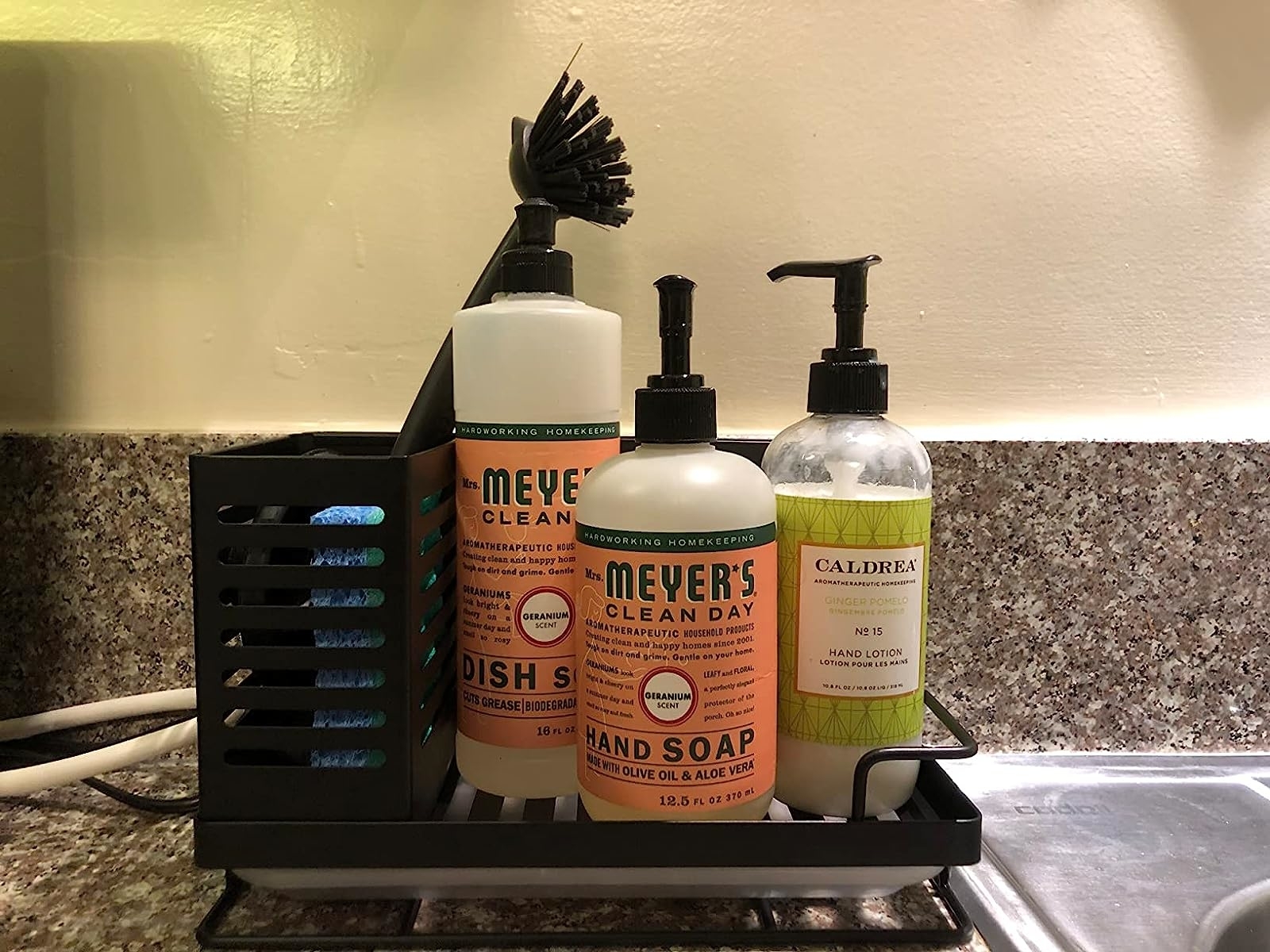 Reviewer's black caddy storing sponges, brush, and soaps