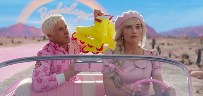 Margot Robbie as &quot;Barbie&quot; driving a convertible with Ryan Gosling as Ken in the backseat holding a set of rollerblades