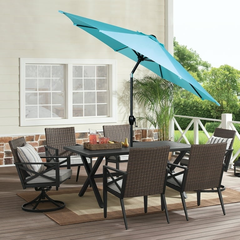 the turquoise umbrella on a patio table set
