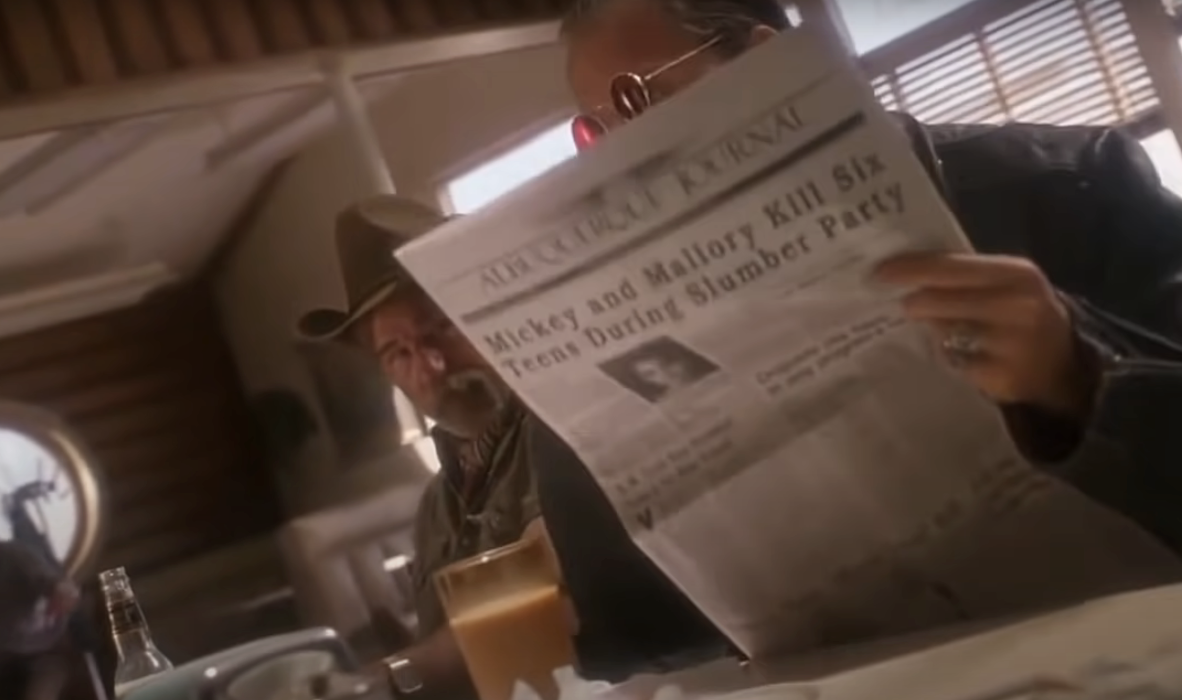 The diner patron holding up a newspaper