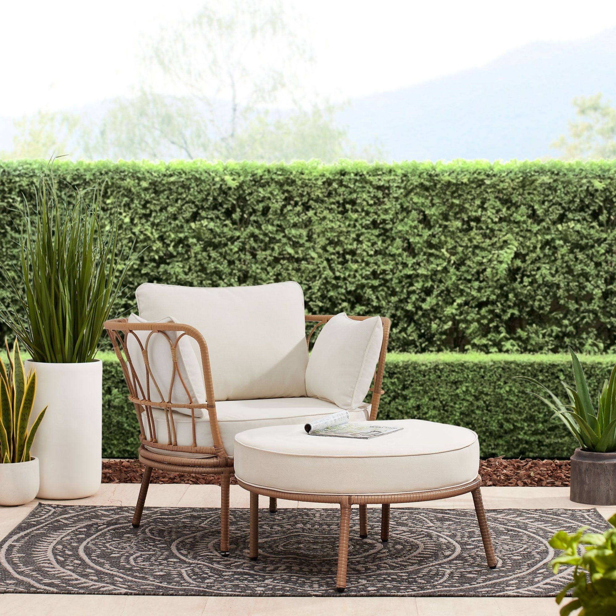 the beige and wicker chair and ottoman set