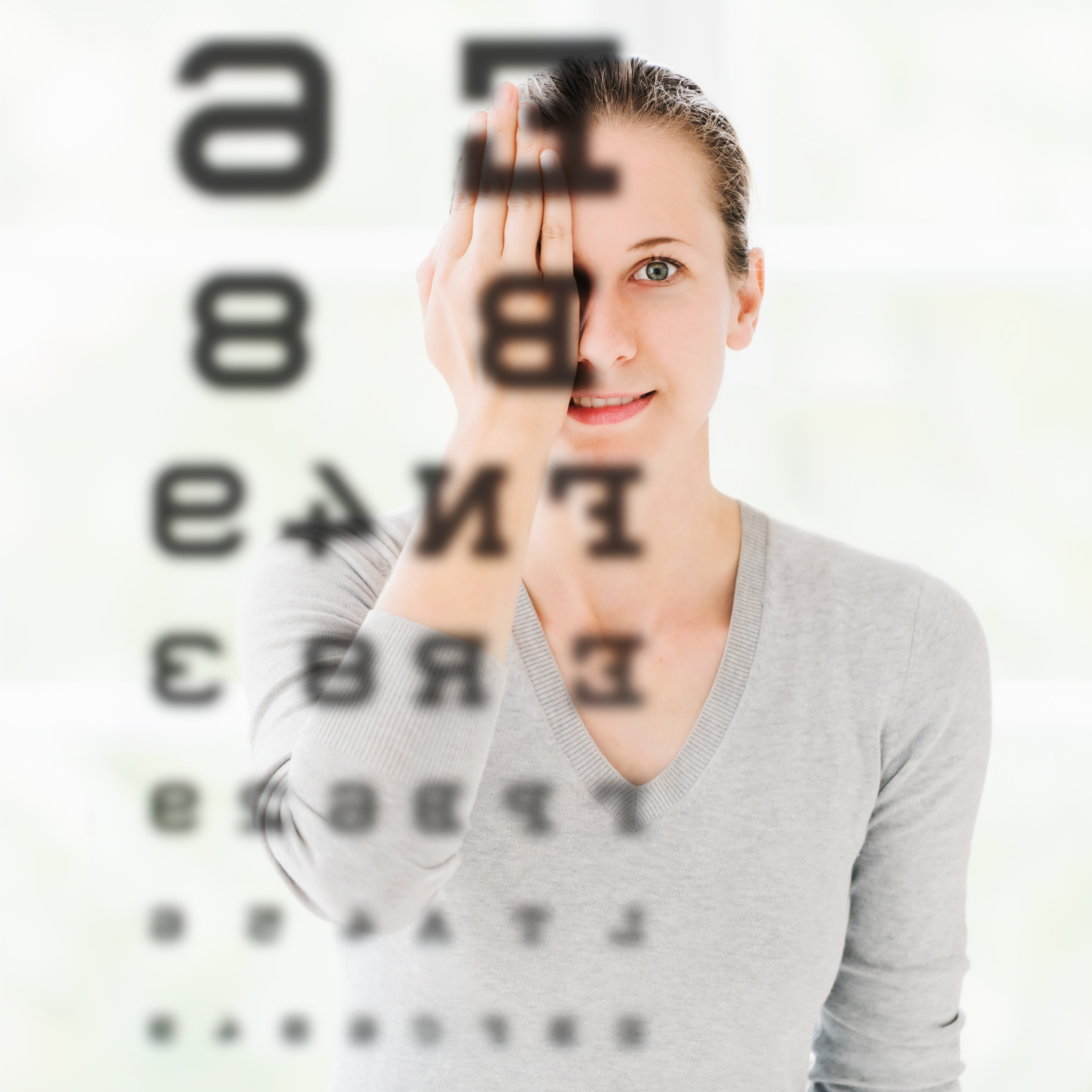 woman reading a chart off the wall during an eye exam