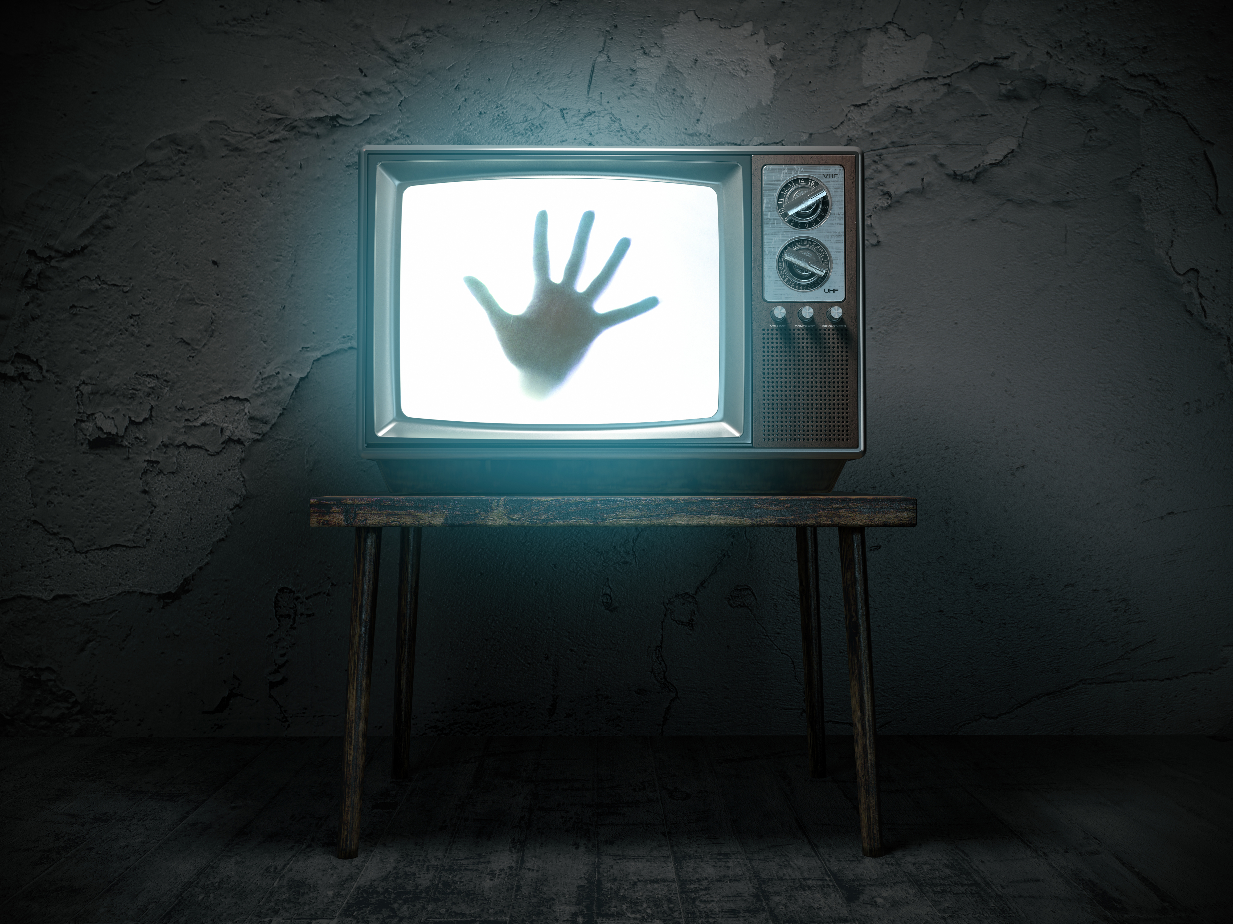 hand reaching out of a tv screen