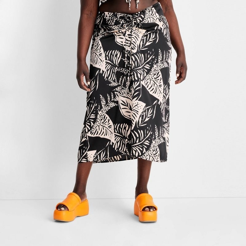 model wearing the skirt with orange flatform shoes