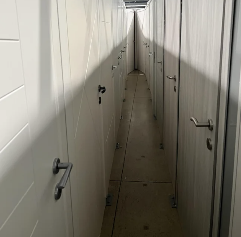 A narrow hall of doors