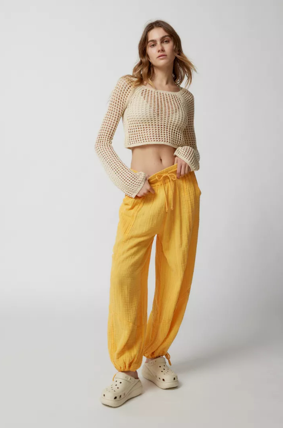 a model wearing the yellow utility pants