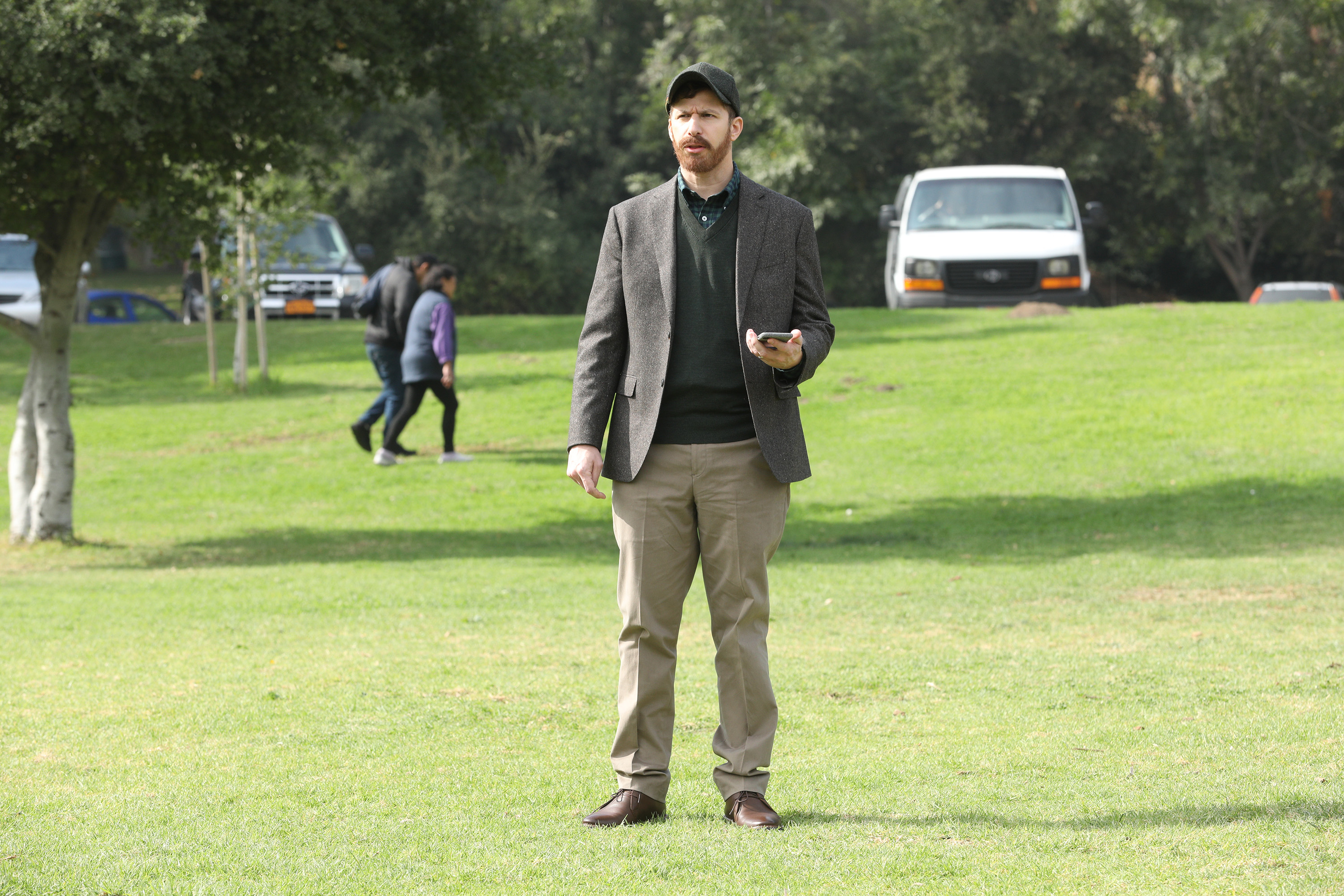 Andy Samberg wears a posh disguise in the middle of a park