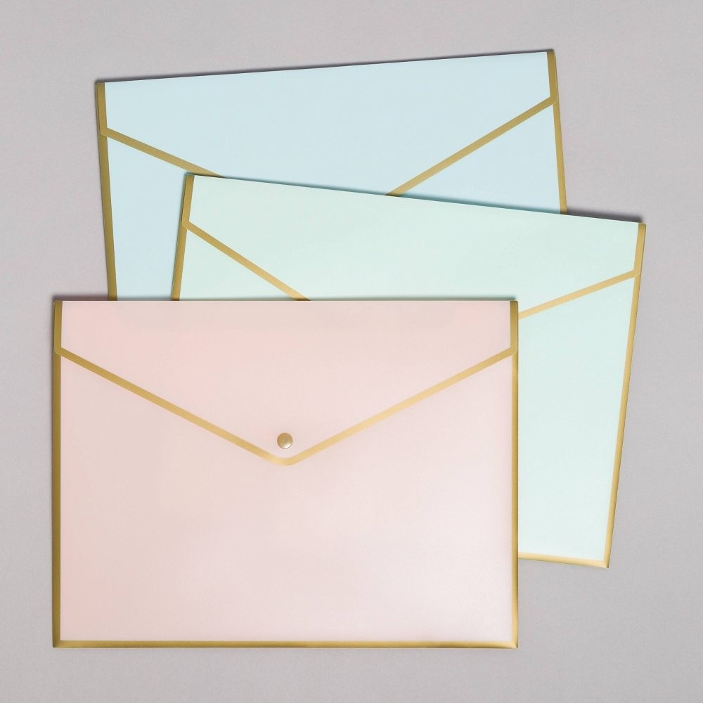 the three folders in pastel pink green and bue