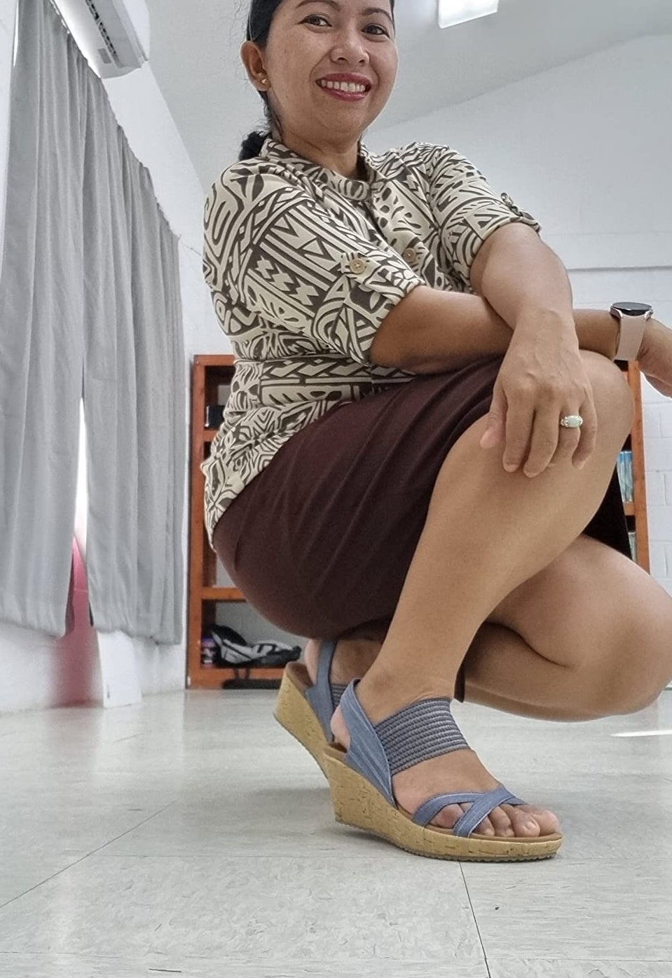 a reviewer wearing the blue sandals