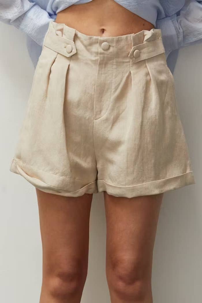 Model wearing beige shorts