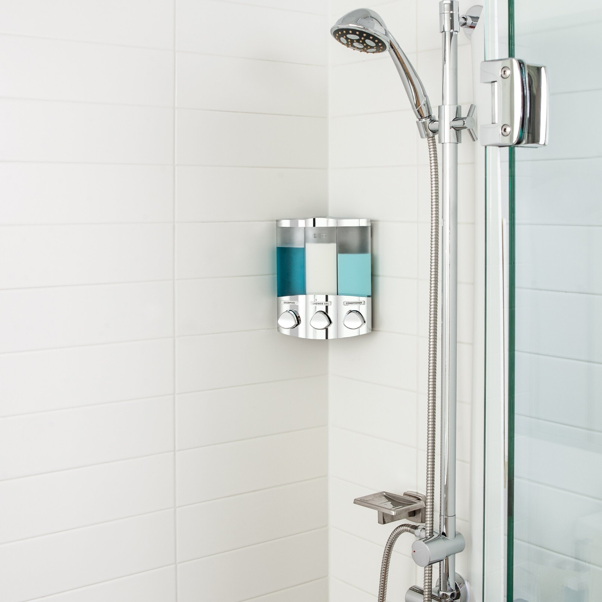 the mounted soap dispenser with three compartments on the wall of a shower