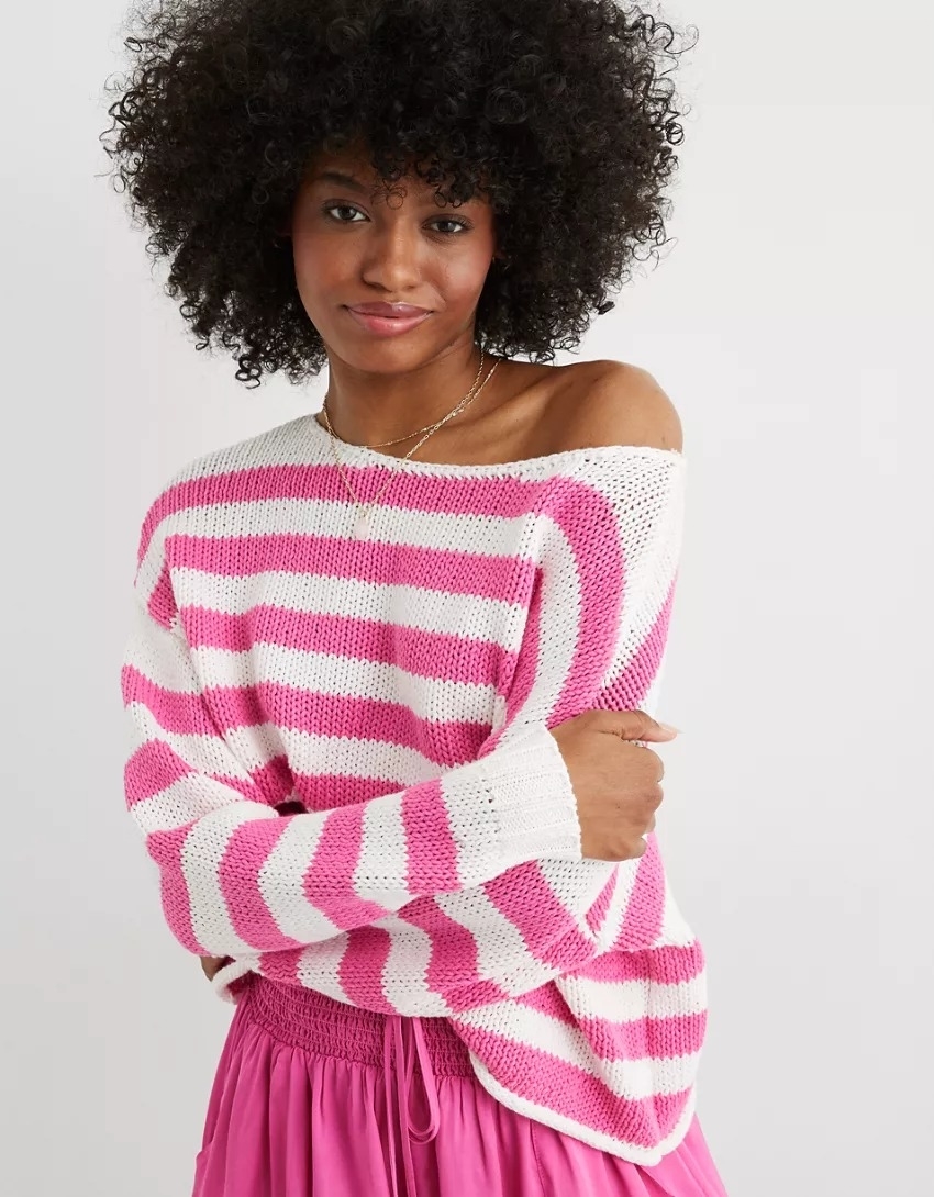 Model wearing the sweater with pink stripes