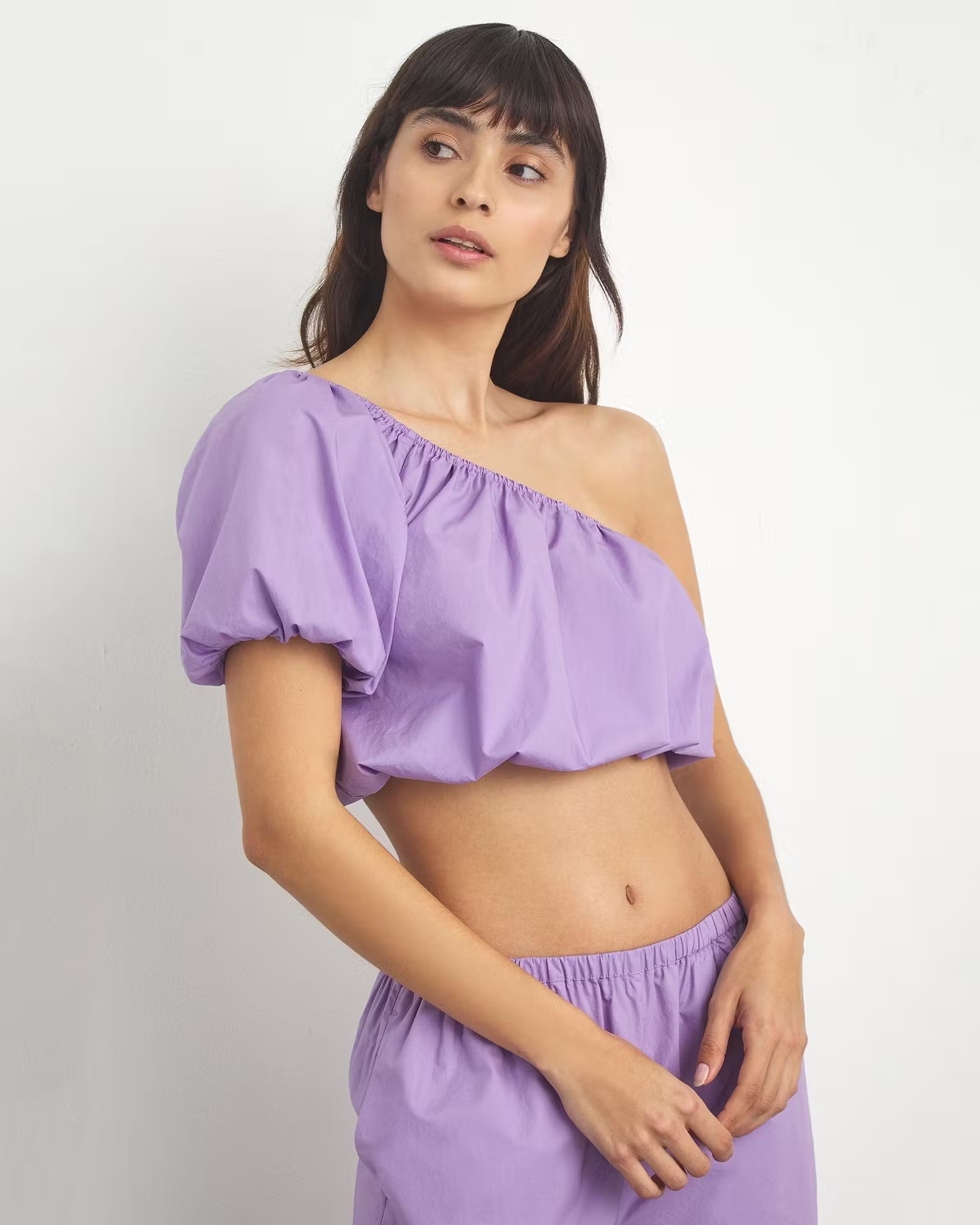 Model wearing purple top and pants