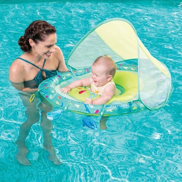 Adult and baby in a pool with baby in the float