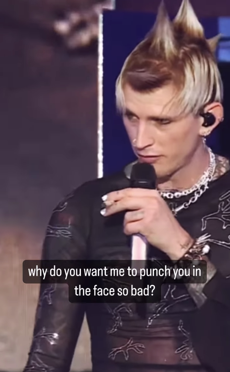 MGK looks down at the audience and asks &quot;why do you want me to punch you in the face so bad?&quot;